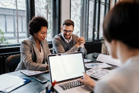 A multiracial executives are sitting at the office and brainstorming about project.